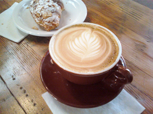 A latte and an Aalmond croissant from Four Barrel Caffee